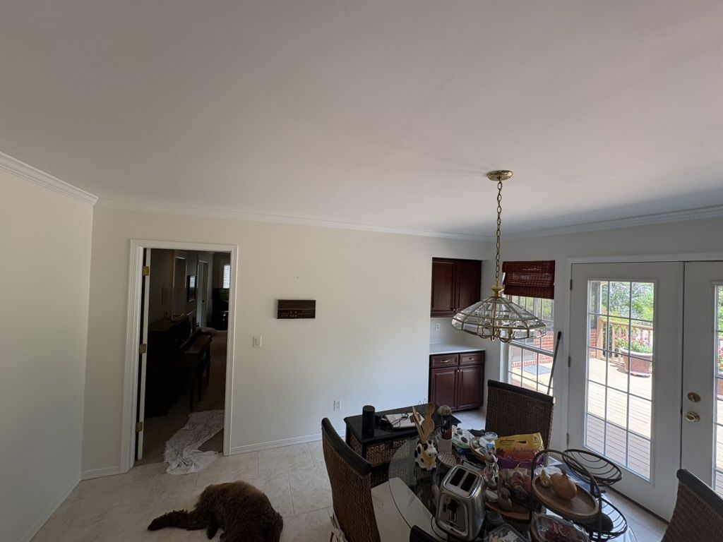 Breakfast nook after painting, with smooth light walls and crisp white crown molding